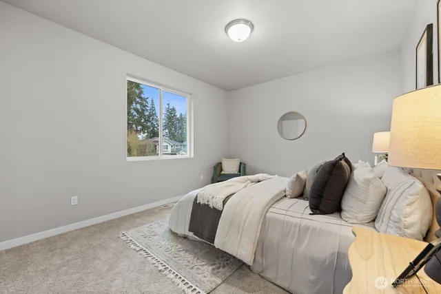 a bedroom with double bed and a potted plant