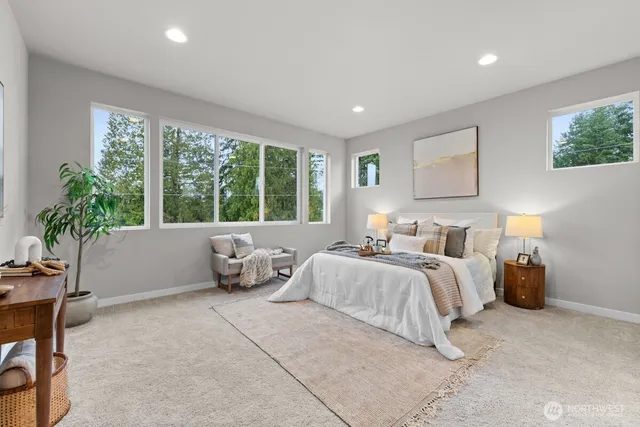 a bedroom with bed and a large window