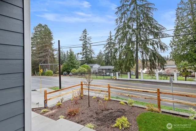 a view of a backyard with wooden fence