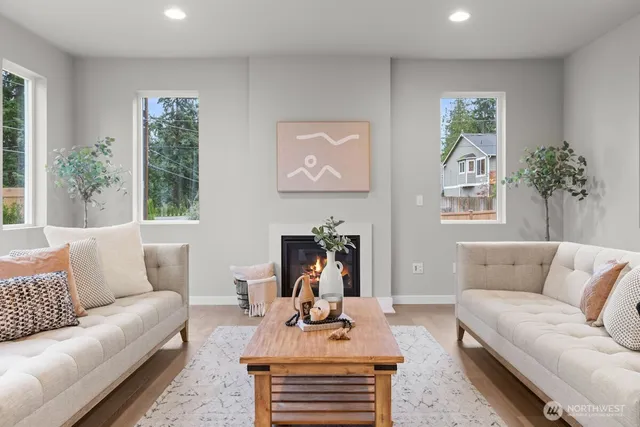 a living room with furniture a window and a fireplace