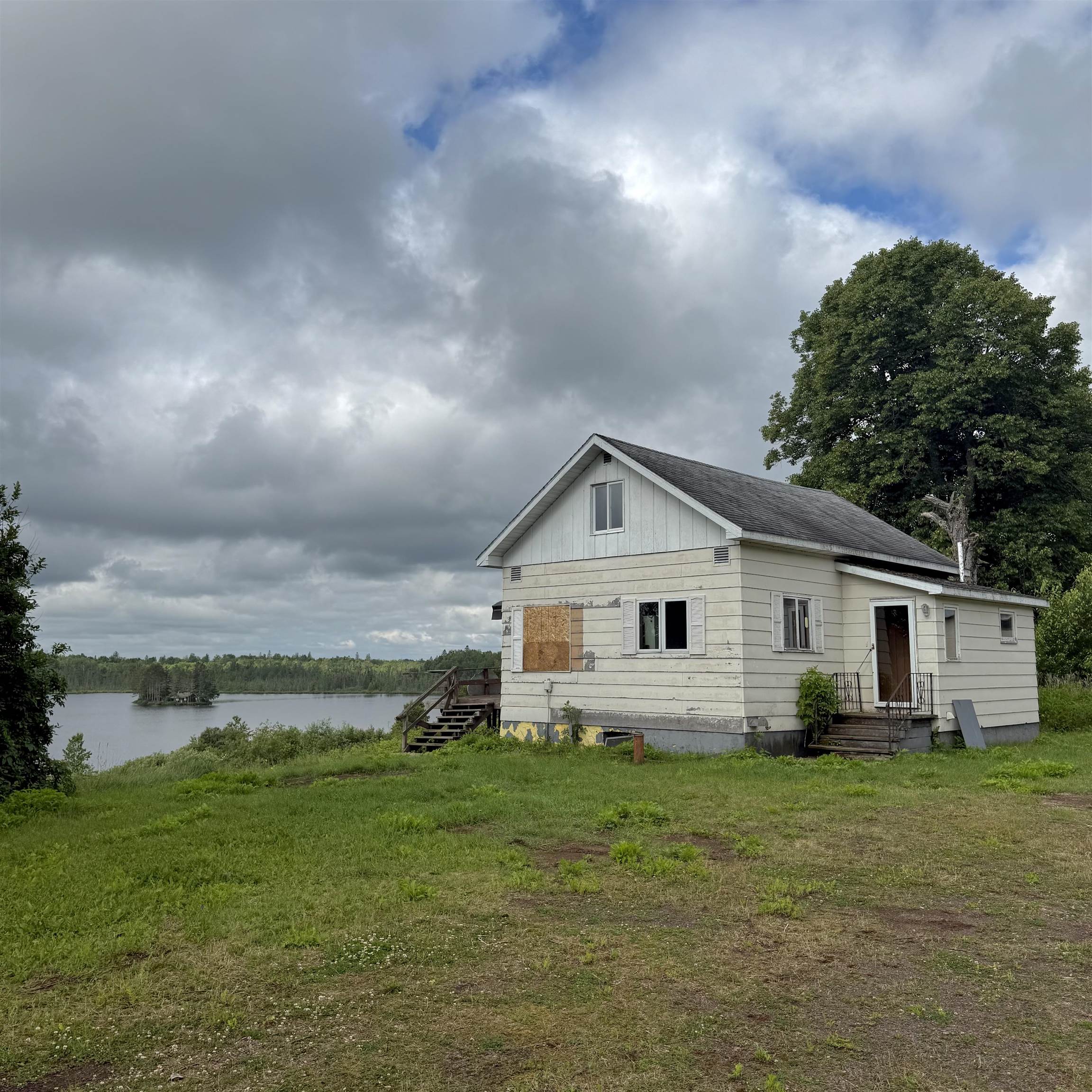 803 Highland Lk Road Two Harbors, MN 55616 - Photo 1 of 23 View of home's exterior featuring a water view and a yard