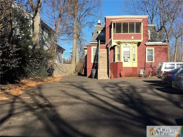 a view of a brick house with many windows