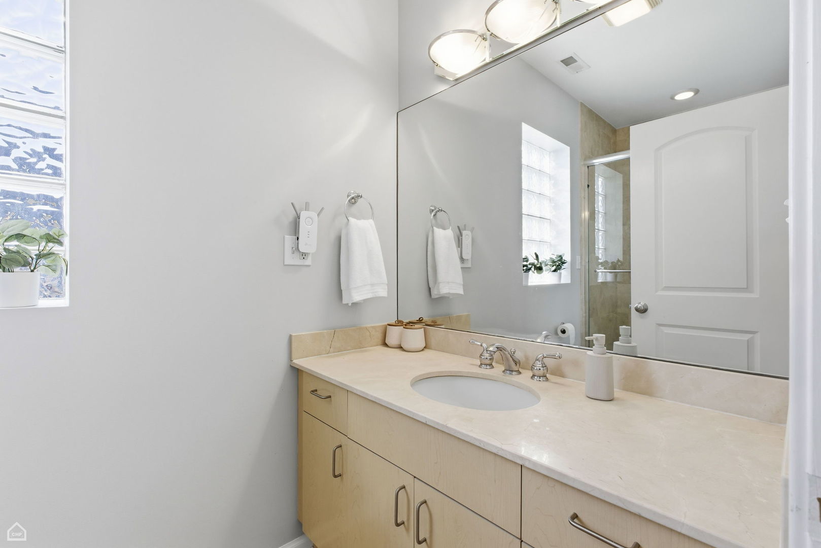 2249 West Foster Avenue, Unit 3 Chicago, IL 60625 - Photo 14 of 19 a bathroom with a sink and a mirror
