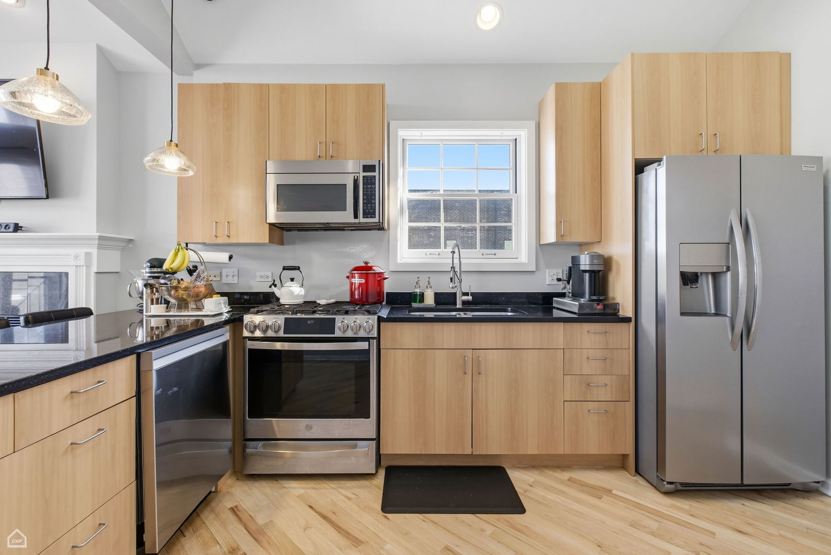 2249 West Foster Avenue, Unit 3 Chicago, IL 60625 - Photo 7 of 19 a kitchen with granite countertop a refrigerator stove and sink