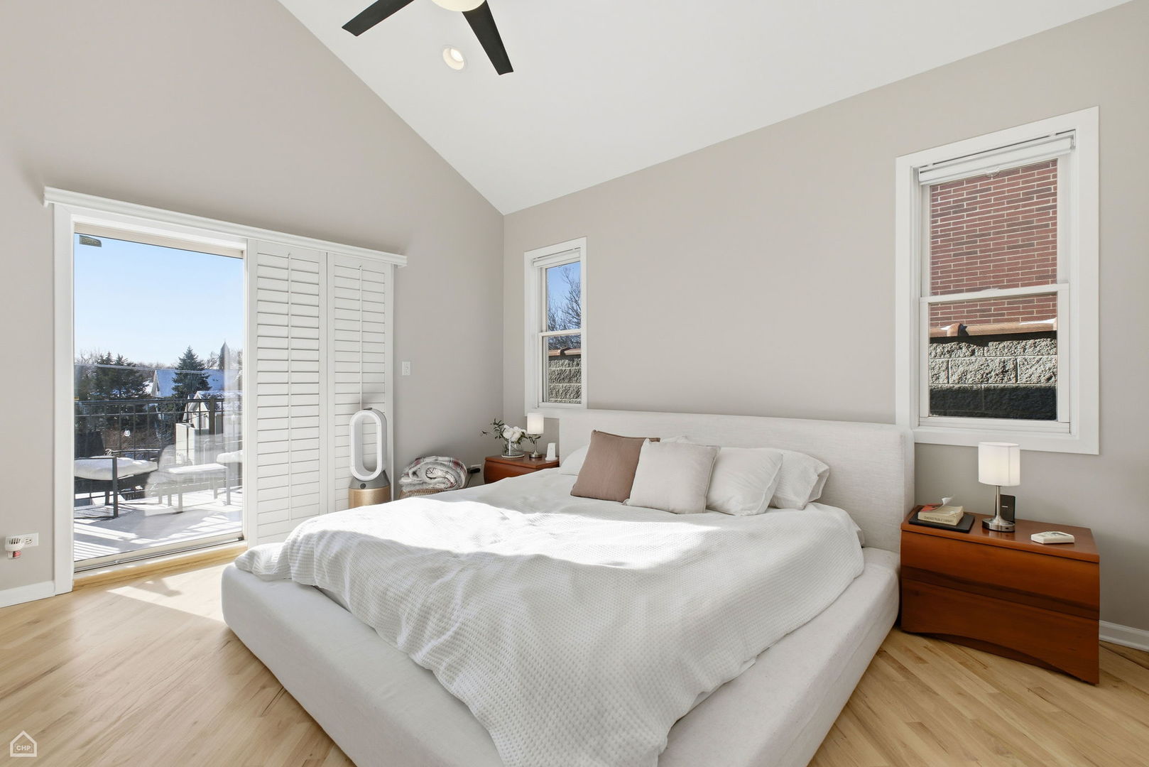 2249 West Foster Avenue, Unit 3 Chicago, IL 60625 - Photo 9 of 19 a bedroom with a bed and wooden floor