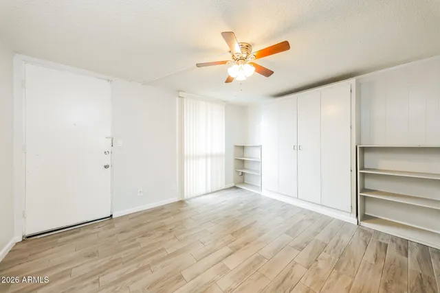 a view of a room with wooden floor and white walls