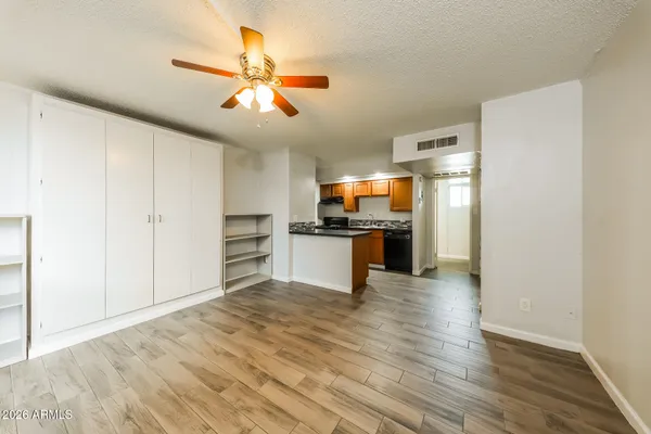 a view of a kitchen with a sink and dishwasher a refrigerator with wooden floor