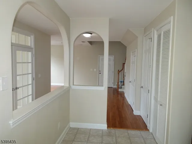 a view of a hallway with wooden floor and entryway