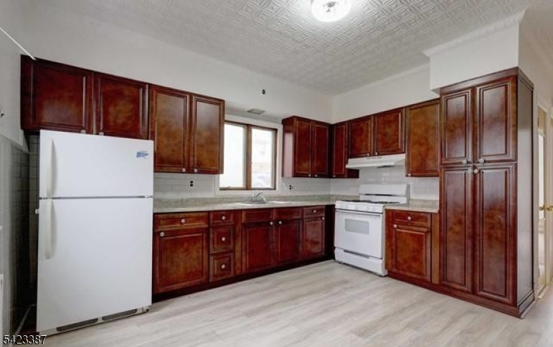 58 Westervelt Avenue Hawthorne, NJ 07506 - Photo 1 of 14 a kitchen with stainless steel appliances granite countertop a refrigerator stove a sink dishwasher and wooden cabinets