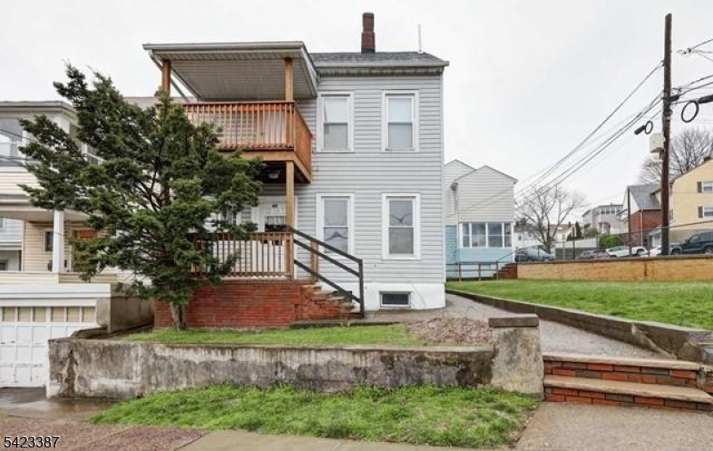 58 Westervelt Avenue Hawthorne, NJ 07506 - Photo 12 of 14 a front view of a house with garden