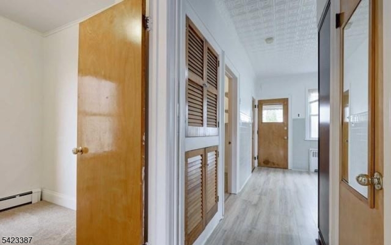 58 Westervelt Avenue Hawthorne, NJ 07506 - Photo 4 of 14 a view of a hallway with wooden floor and closet area