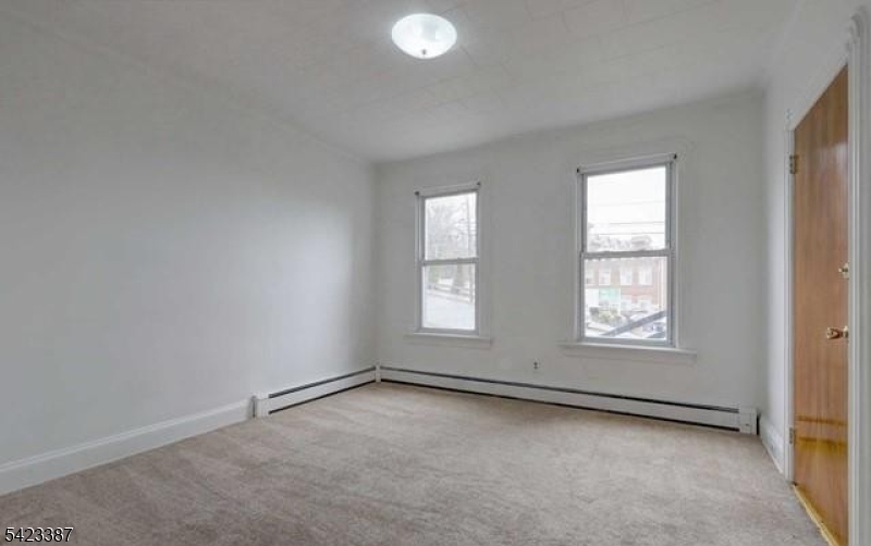 58 Westervelt Avenue Hawthorne, NJ 07506 - Photo 6 of 14 an empty room with windows