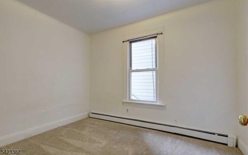 58 Westervelt Avenue Hawthorne, NJ 07506 - Photo 9 of 14 an empty room with a window
