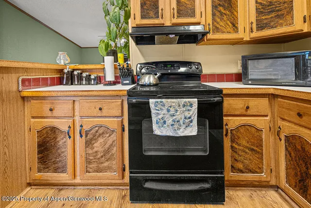 a utility room with stainless steel appliances lots of counter space and cabinets