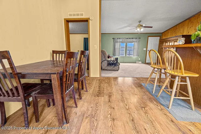a view of a dining room with furniture and a chandelier