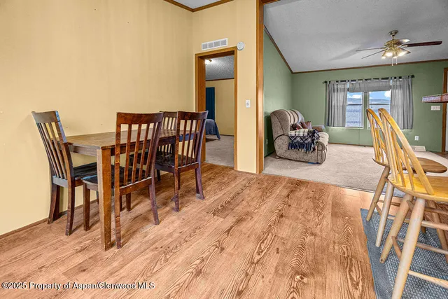 a dining room with furniture and wooden floor