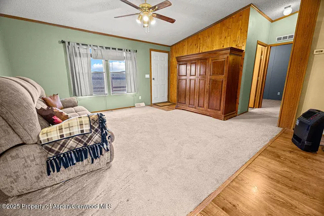 a living room with furniture hardwood floor and a large window