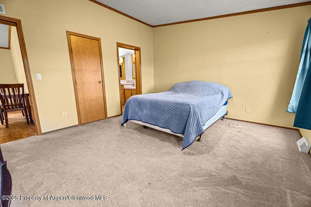 a view of an empty room with window and a bathroom