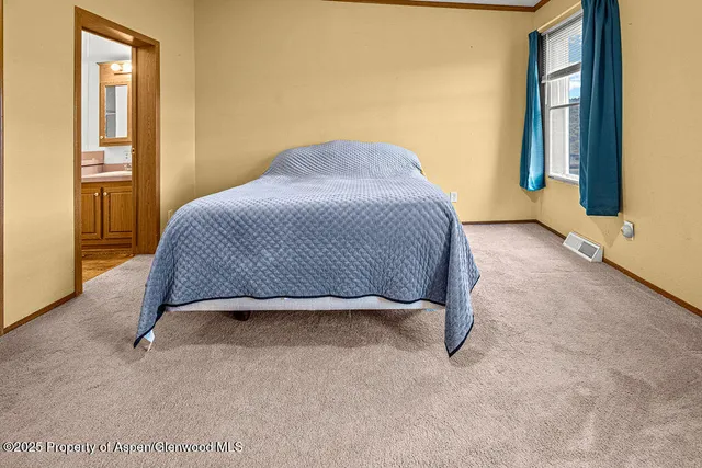 a bedroom with a bed and a table