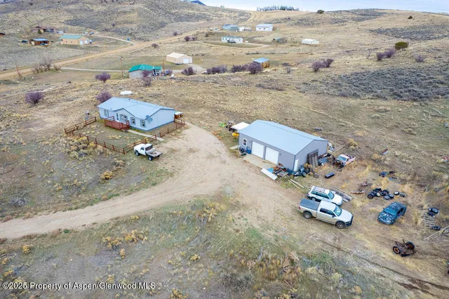 an aerial view of a house with a yard