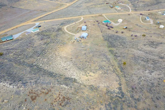 a view of a kitchen with stainless steel appliances granite countertop a stove a sink and a refrigerator
