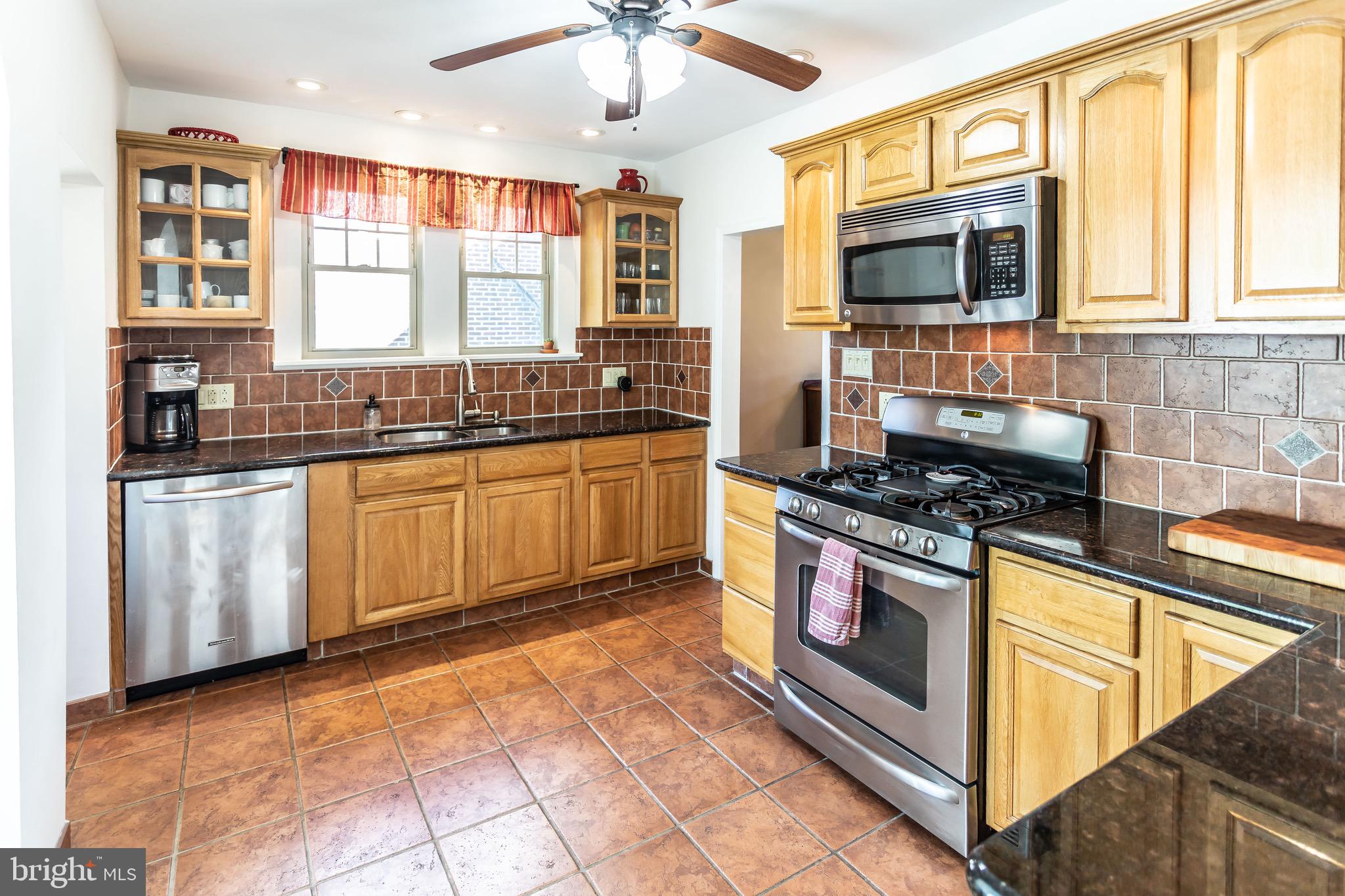 105 West Clearfield Road Havertown, PA 19083 - Photo 18 of 56 a kitchen with stainless steel appliances granite countertop a stove sink and microwave