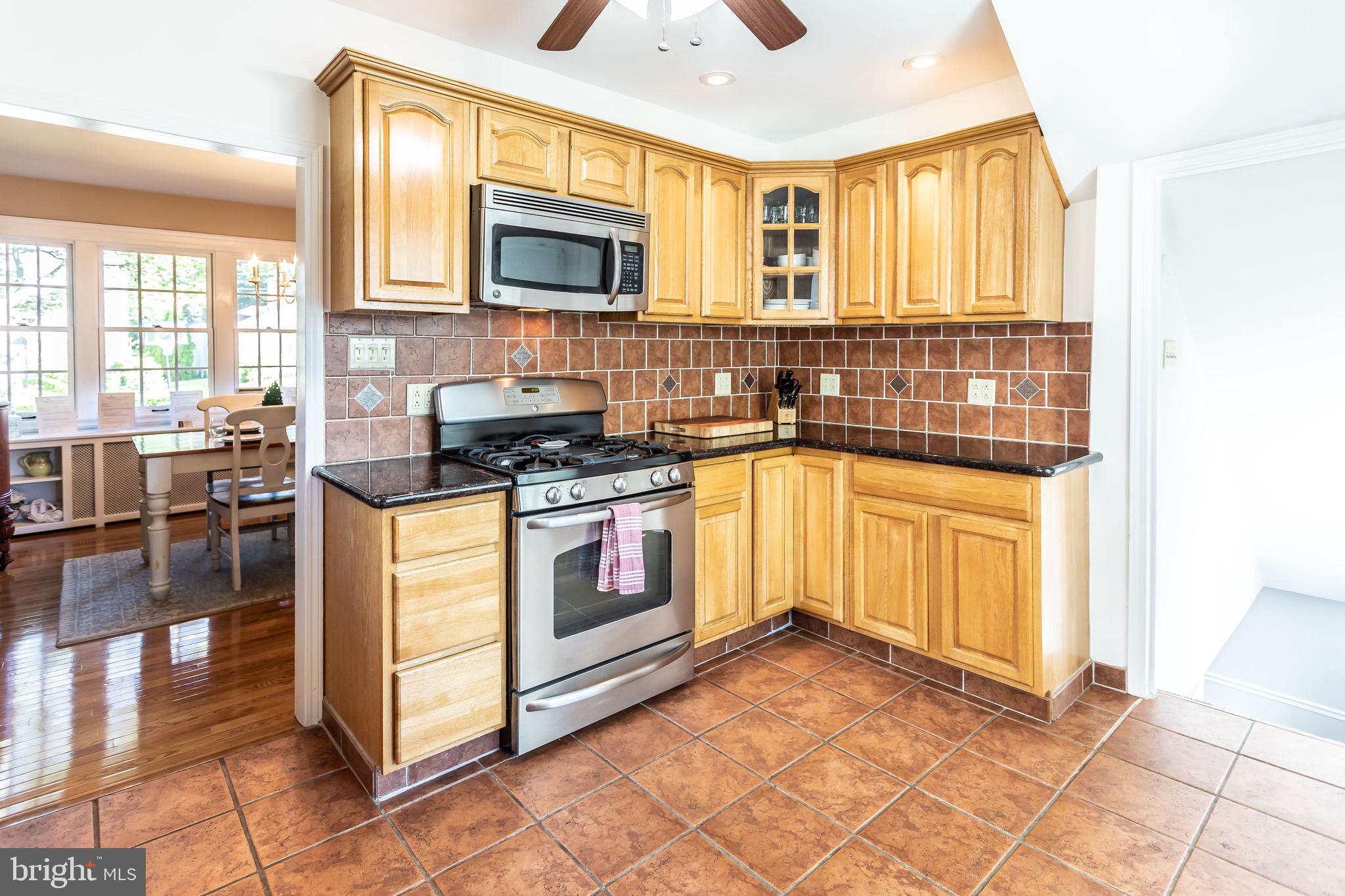 105 West Clearfield Road Havertown, PA 19083 - Photo 19 of 56 a kitchen with stainless steel appliances granite countertop a stove a sink and a microwave