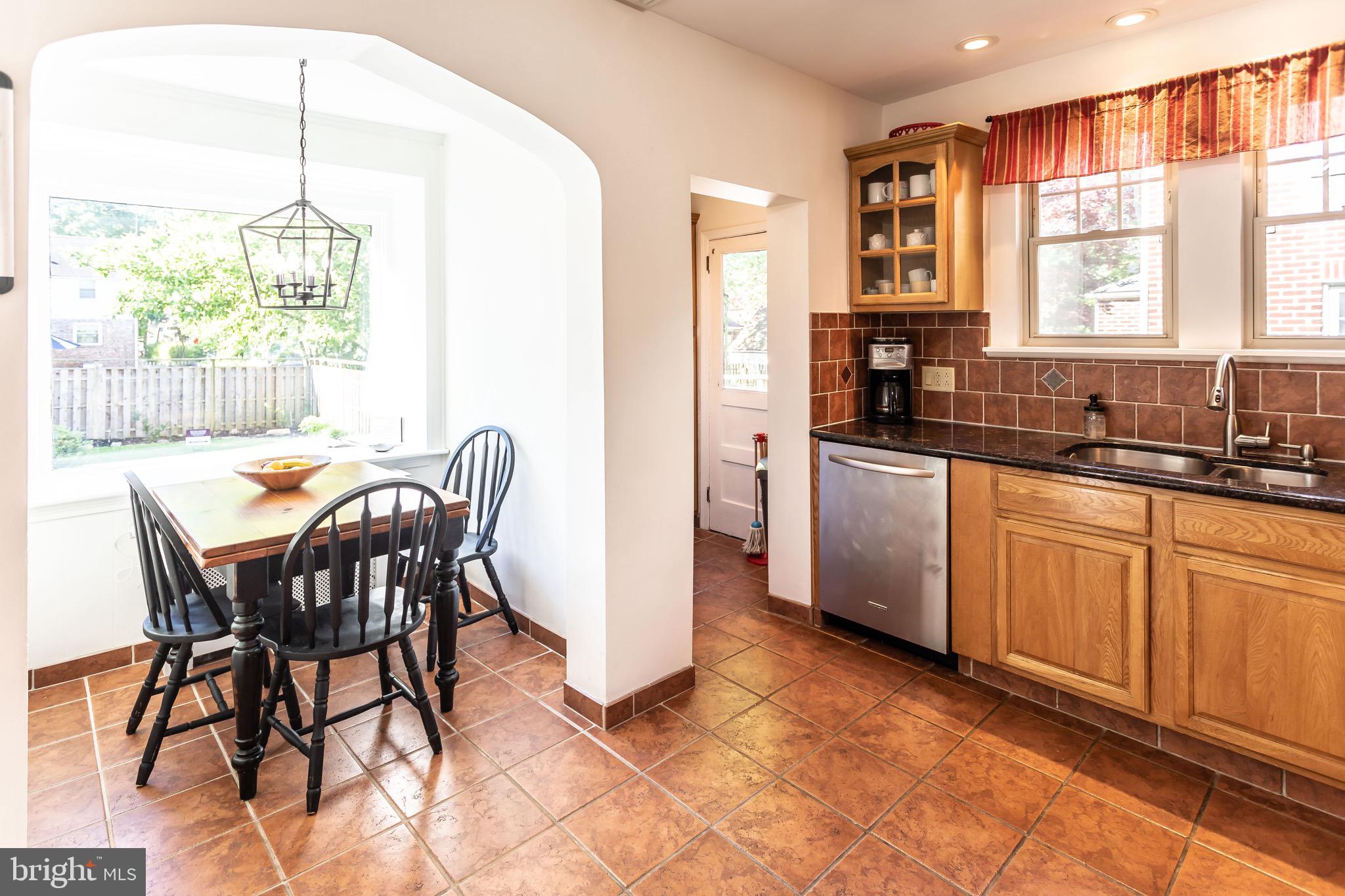 105 West Clearfield Road Havertown, PA 19083 - Photo 21 of 56 a kitchen with stainless steel appliances granite countertop table chairs sink and window