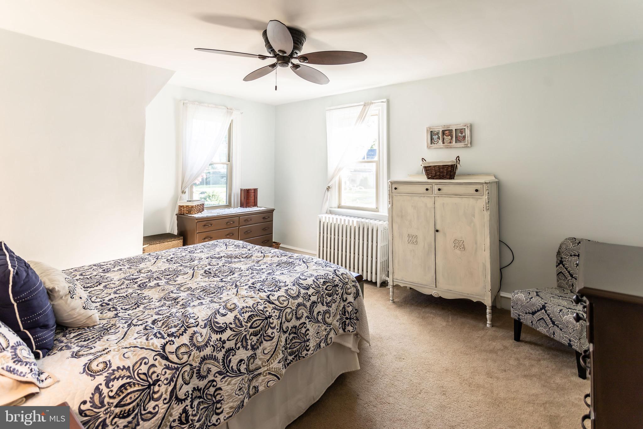 105 West Clearfield Road Havertown, PA 19083 - Photo 25 of 56 a bedroom with a bed a dresser and a window