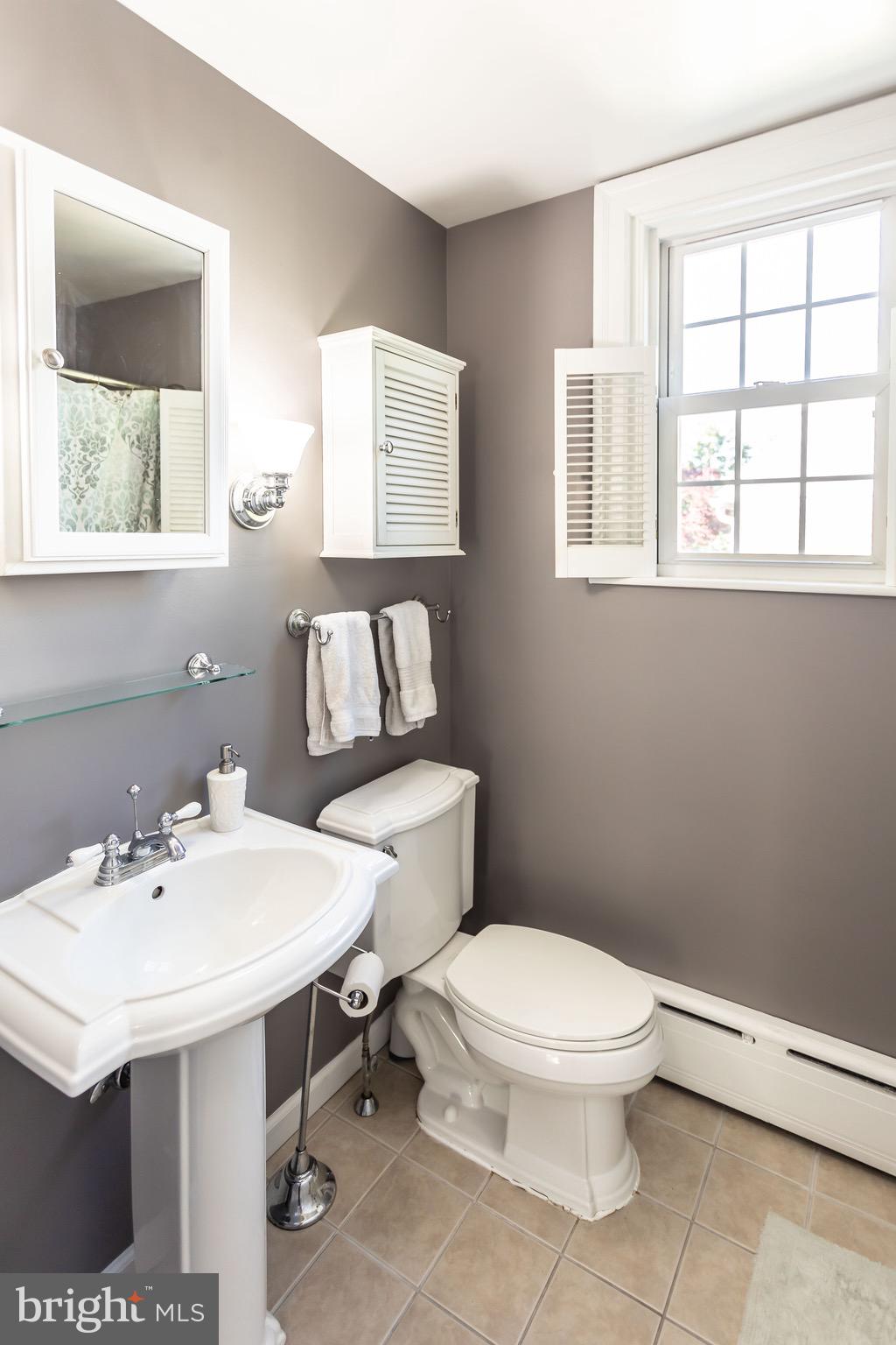 105 West Clearfield Road Havertown, PA 19083 - Photo 28 of 56 a bathroom with a sink a toilet and a window