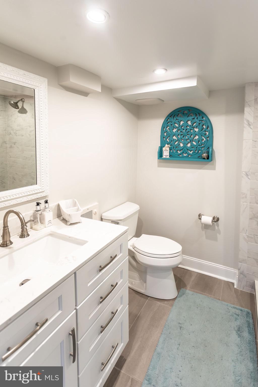 105 West Clearfield Road Havertown, PA 19083 - Photo 43 of 56 a bathroom with a granite countertop toilet sink and mirror