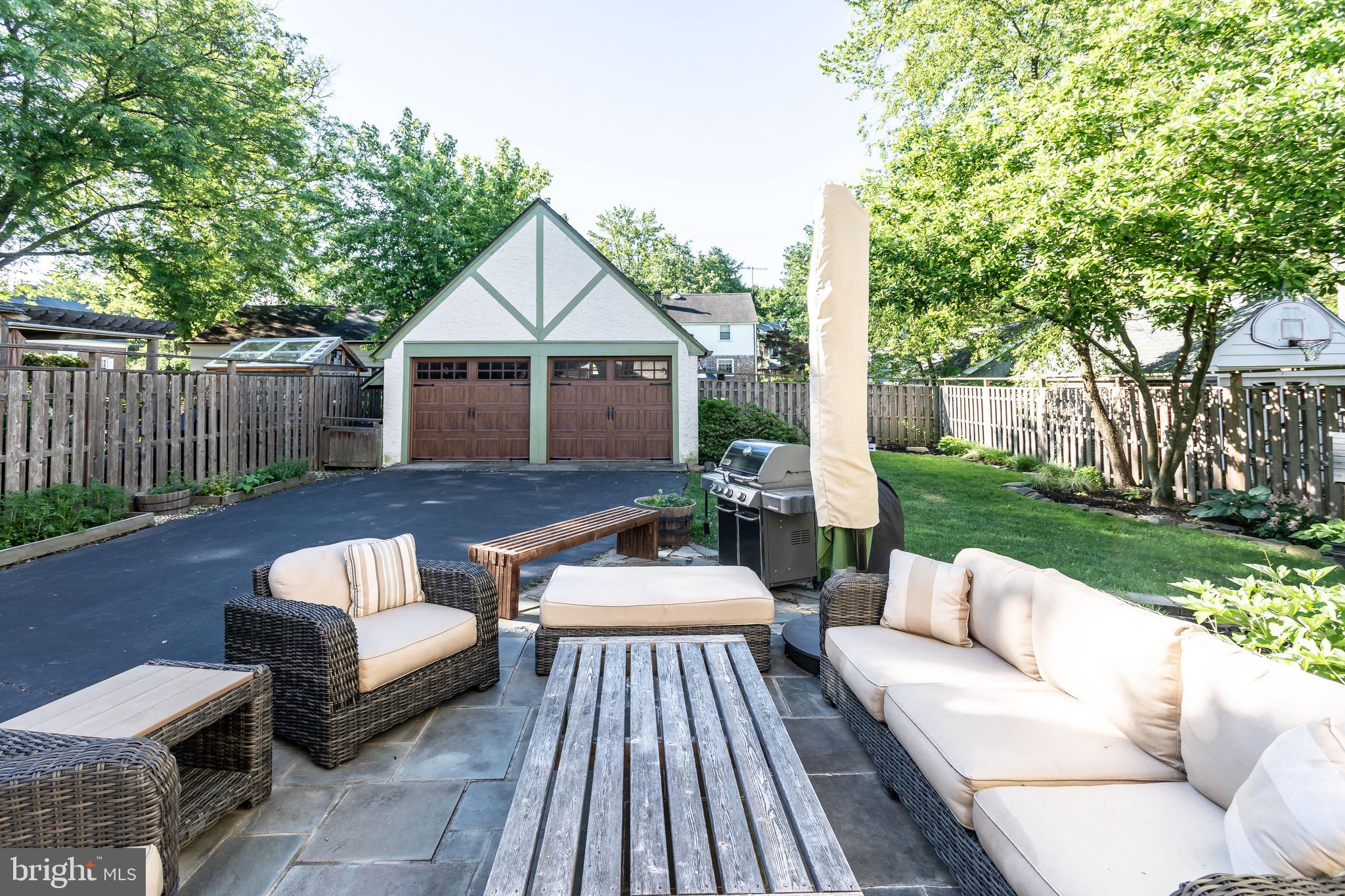 105 West Clearfield Road Havertown, PA 19083 - Photo 56 of 56 a view of a patio with couches table and chairs with wooden fence and floor
