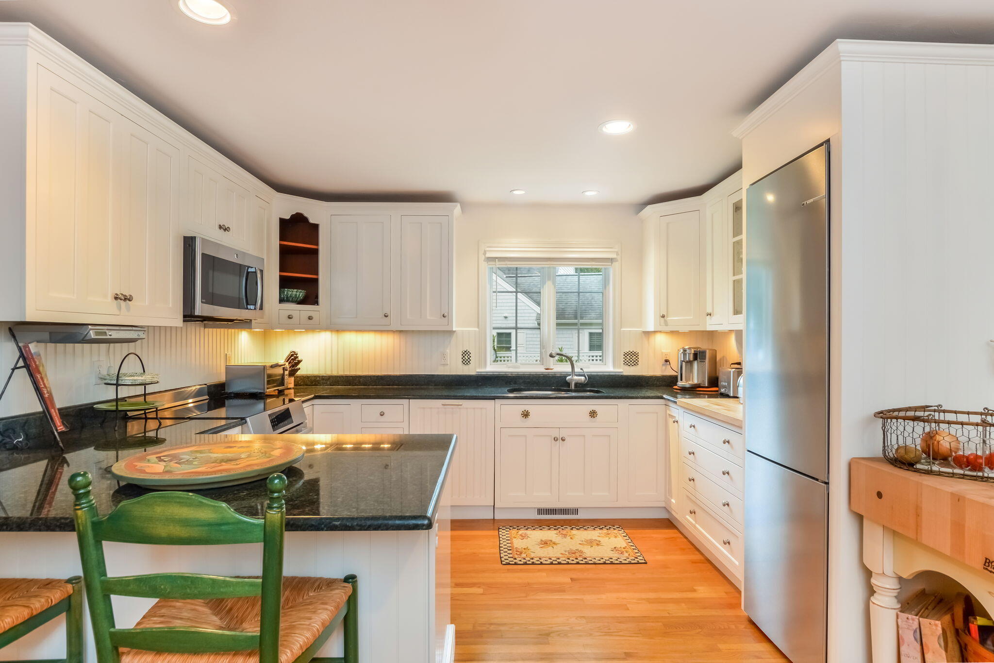 195 Cotuit Road, Unit 8 Marstons Mills, MA 02648 - Photo 12 of 46 a kitchen with stainless steel appliances granite countertop a stove top oven a sink refrigerator and cabinets
