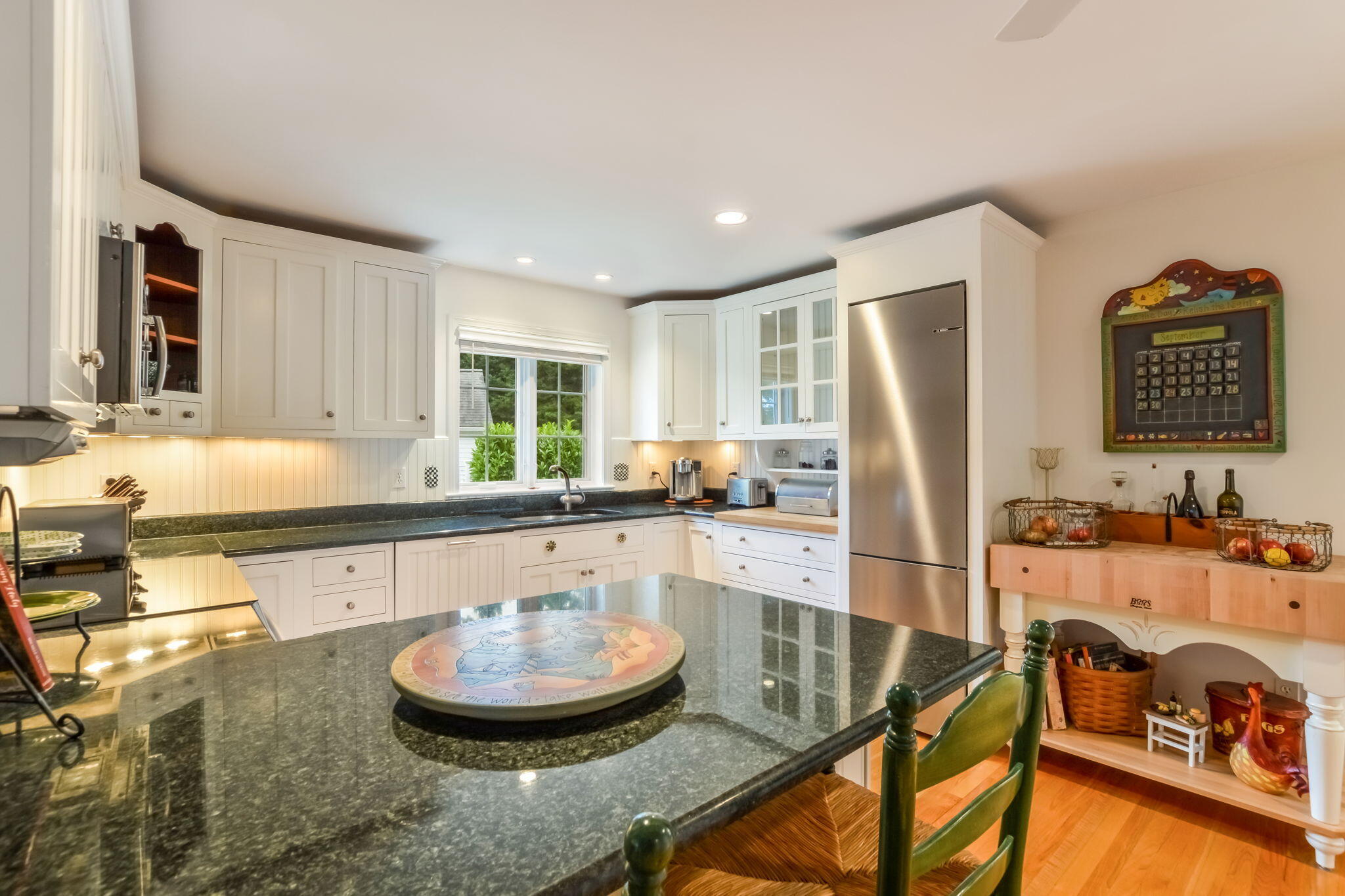 195 Cotuit Road, Unit 8 Marstons Mills, MA 02648 - Photo 14 of 46 a large kitchen with a table and chairs