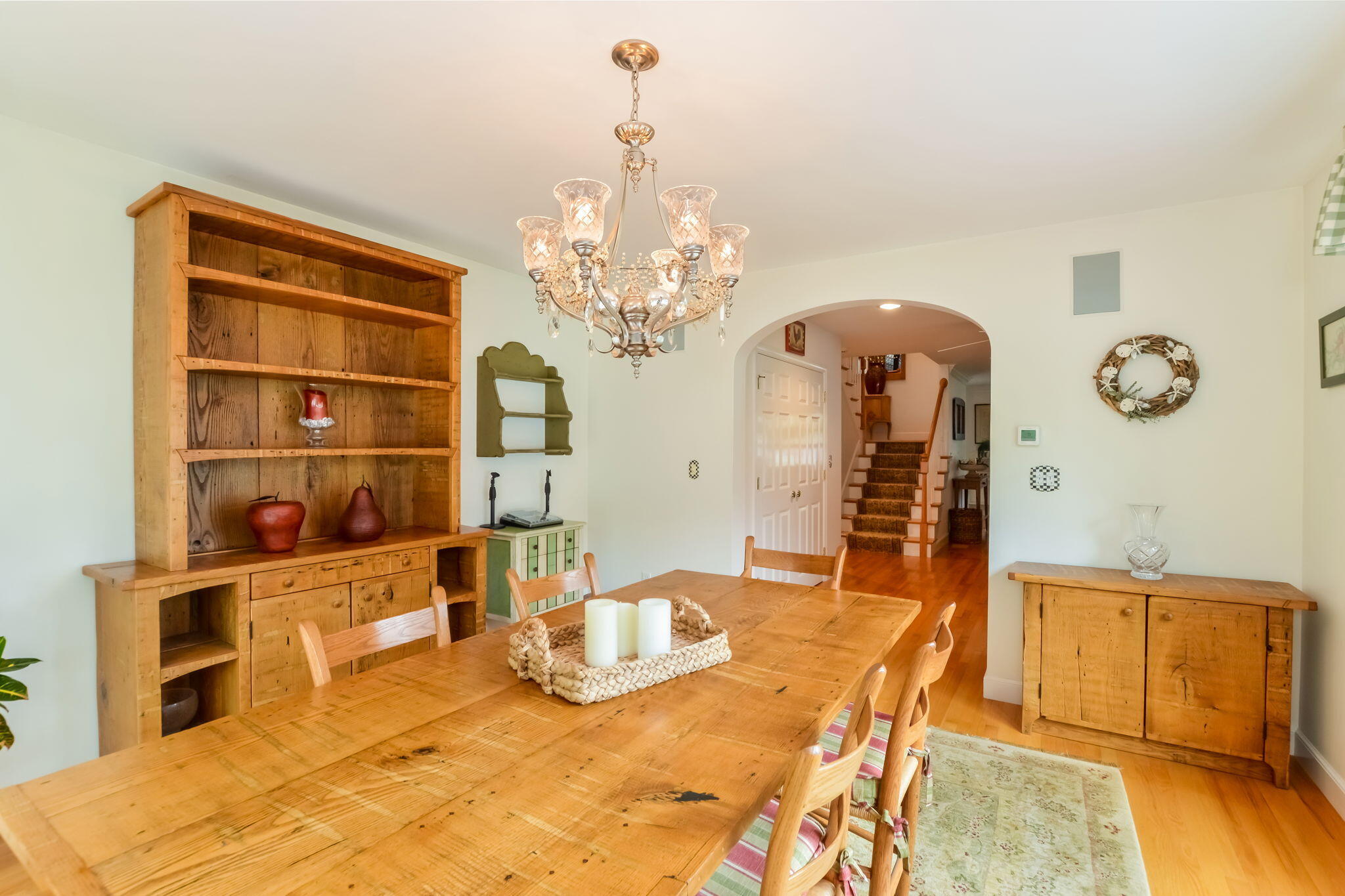 195 Cotuit Road, Unit 8 Marstons Mills, MA 02648 - Photo 17 of 46 a dining room with wooden floor and chandelier