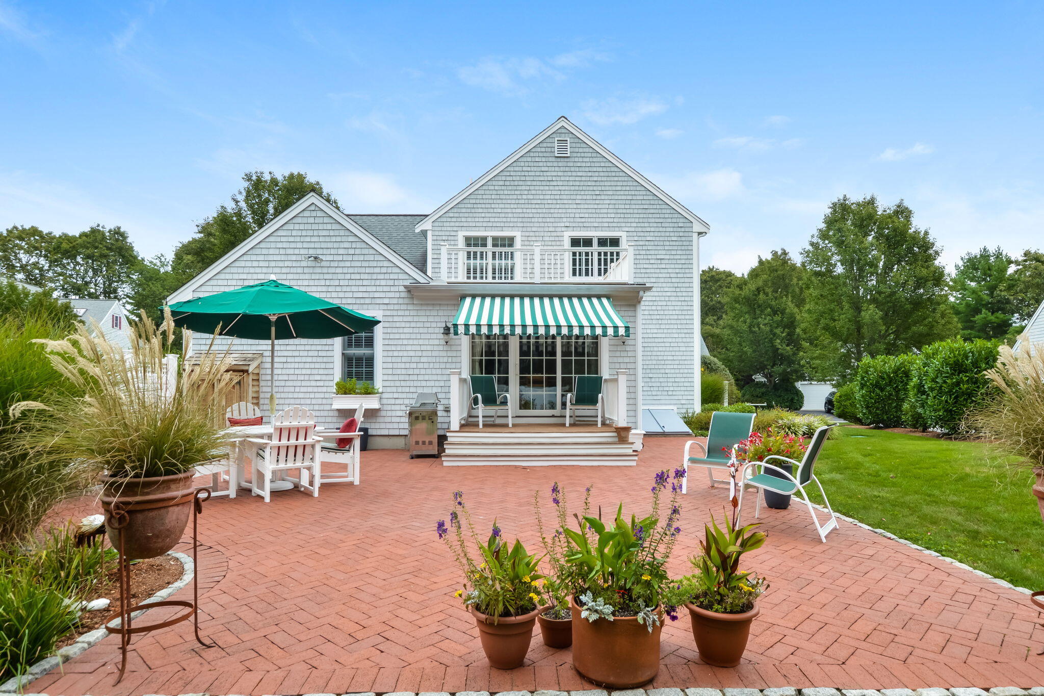 195 Cotuit Road, Unit 8 Marstons Mills, MA 02648 - Photo 39 of 46 a front view of a house with porch and sitting area