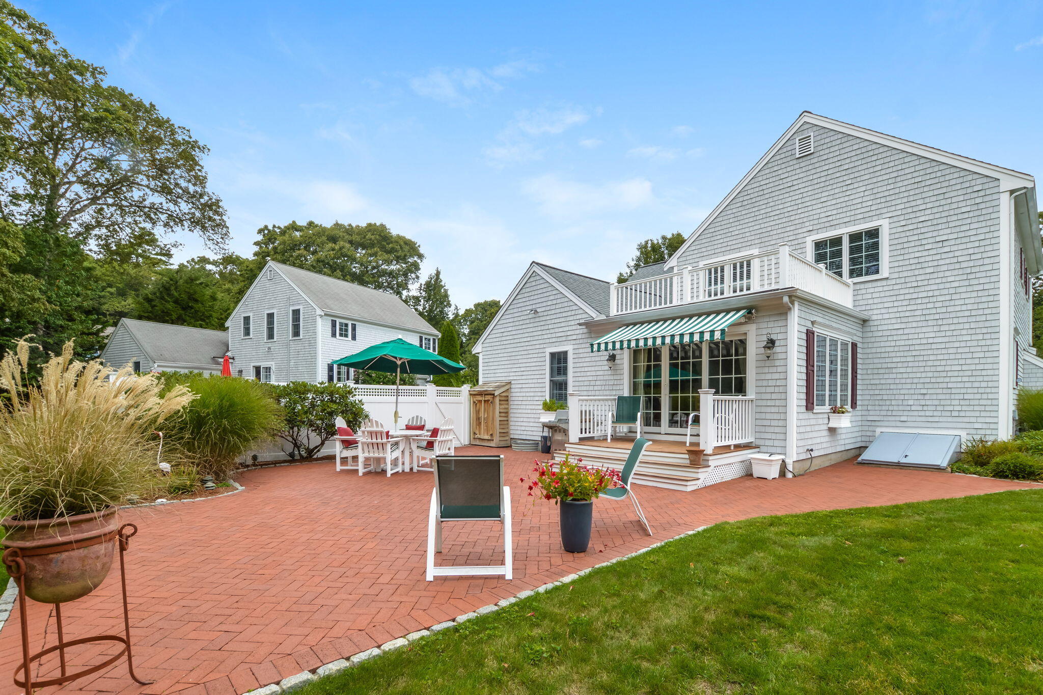 195 Cotuit Road, Unit 8 Marstons Mills, MA 02648 - Photo 40 of 46 a front view of house with yard and outdoor seating
