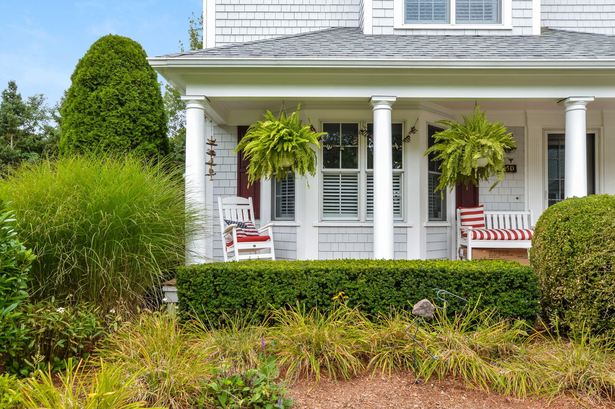 195 Cotuit Road, Unit 8 Marstons Mills, MA 02648 - Photo 4 of 46 a view of a house with a flower garden