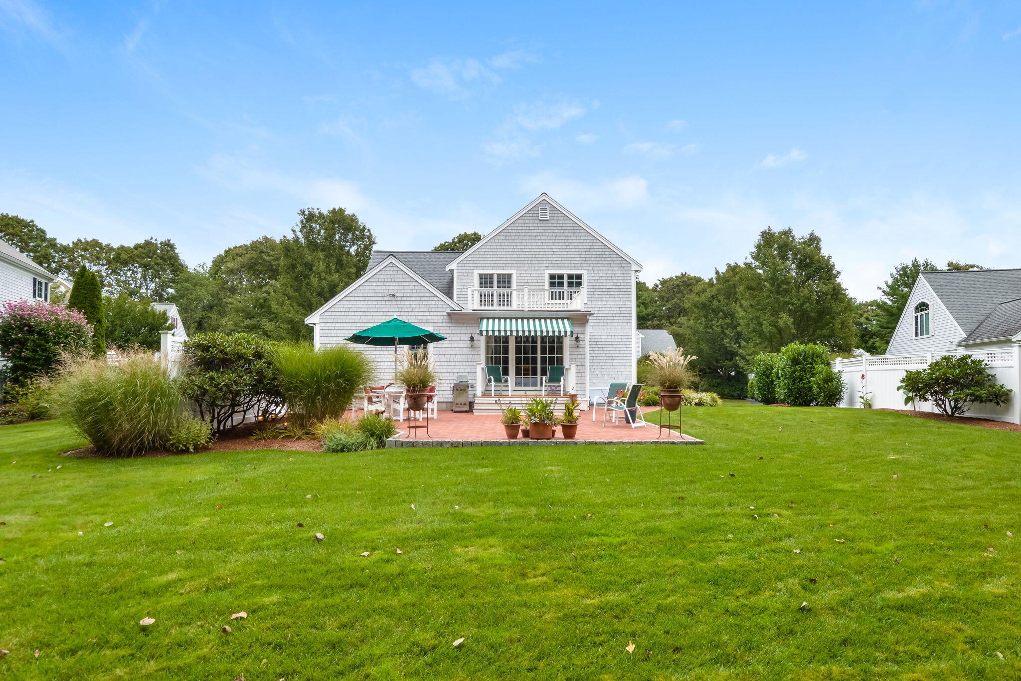 195 Cotuit Road, Unit 8 Marstons Mills, MA 02648 - Photo 43 of 46 a front view of a house with garden and trees
