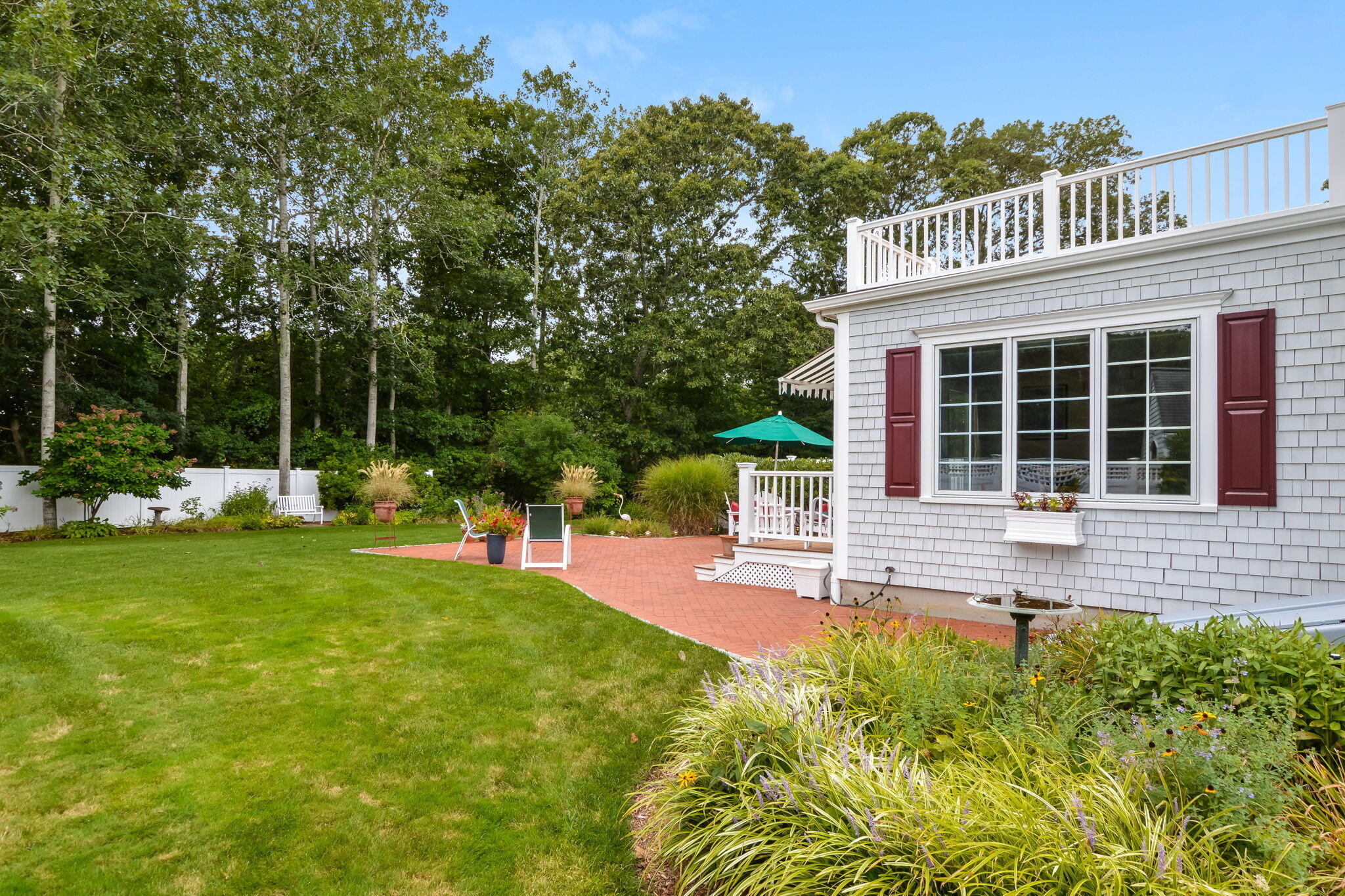 195 Cotuit Road, Unit 8 Marstons Mills, MA 02648 - Photo 44 of 46 a front view of a house with a yard