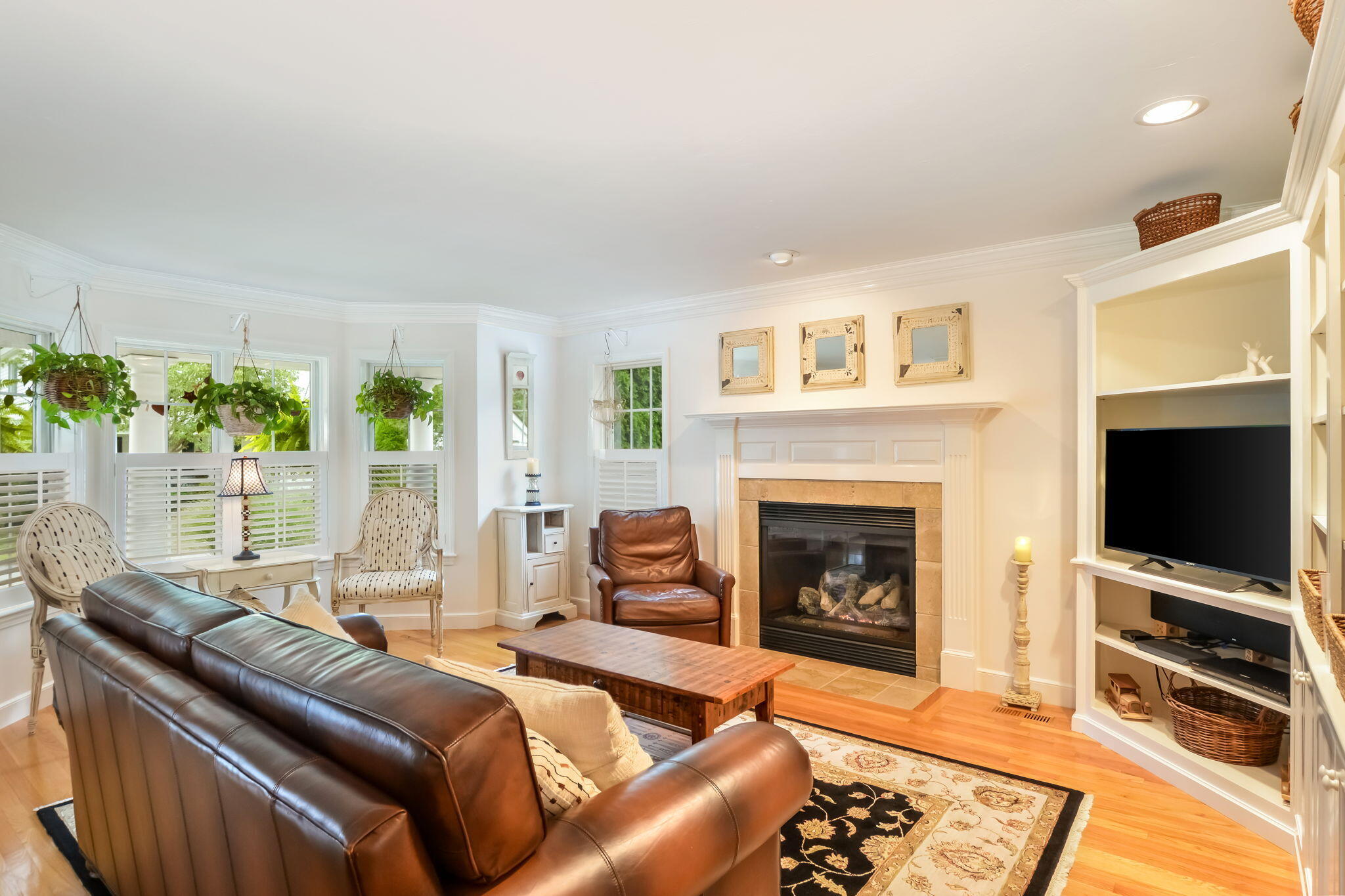 195 Cotuit Road, Unit 8 Marstons Mills, MA 02648 - Photo 8 of 46 a living room with furniture a flat screen tv and a fireplace