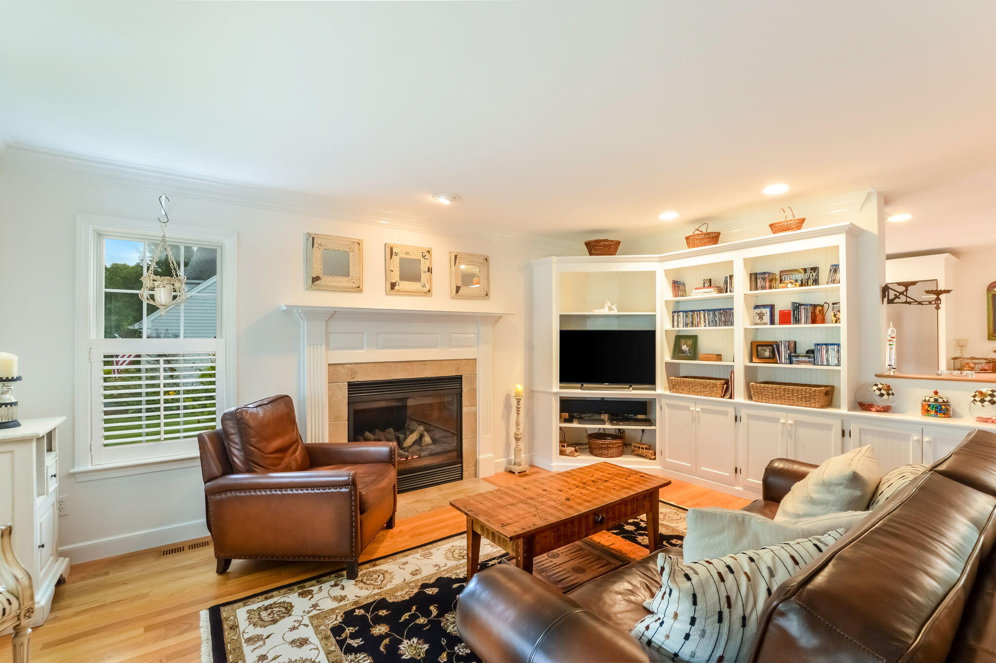 195 Cotuit Road, Unit 8 Marstons Mills, MA 02648 - Photo 9 of 46 a living room with furniture a flat screen tv and a fireplace