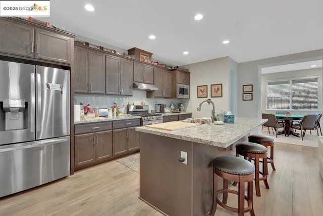a kitchen with granite countertop a sink stove and cabinets