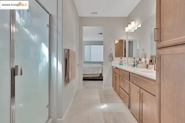 a spacious bedroom with a bed and a cabinets