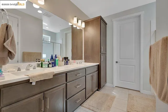 a bathroom with a double vanity sink and a mirror