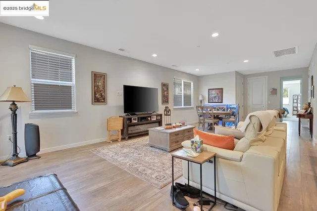 a living room with fireplace furniture and a wooden floor