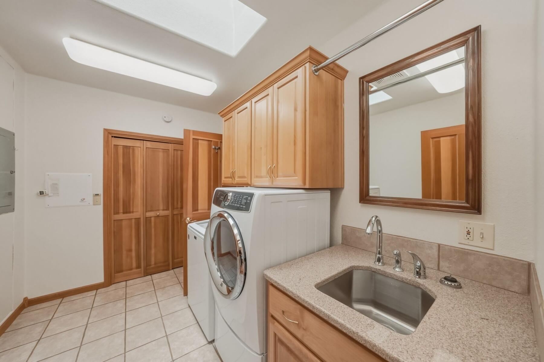 637 Northwest Silver Buckle Road Bend, OR 97703 - Photo 24 of 68 a bathroom with a sink a washer and dryer