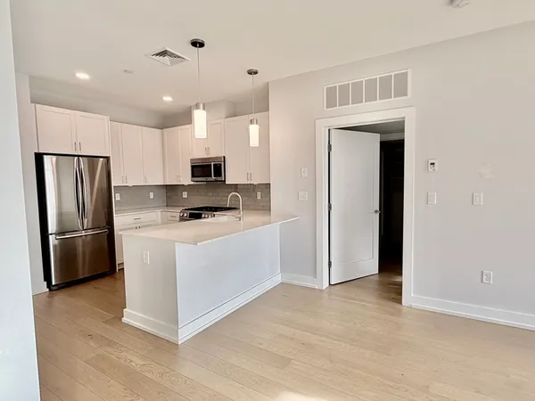 a kitchen with stainless steel appliances a refrigerator sink and stove