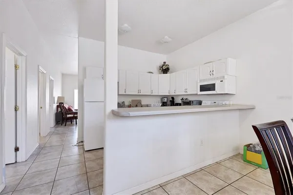 a view of a dining room with furniture and a chandelier