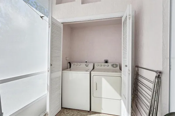 a living room with furniture a window and a potted plant